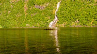 Kayakers and Bringefossen Waterfall in Geirangerfjord